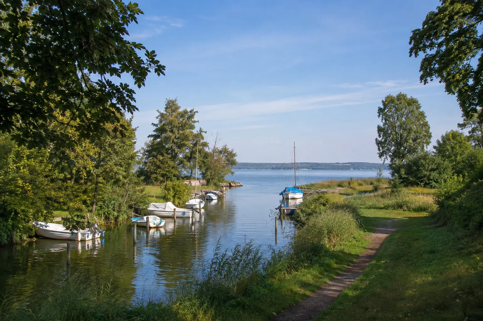 Seedorfer Boddenlandschaft: kleiner Hafen am schmalen Wasserlauf mit niedrigen grünen Ufern und Boddenblick, keine große Seebrücke